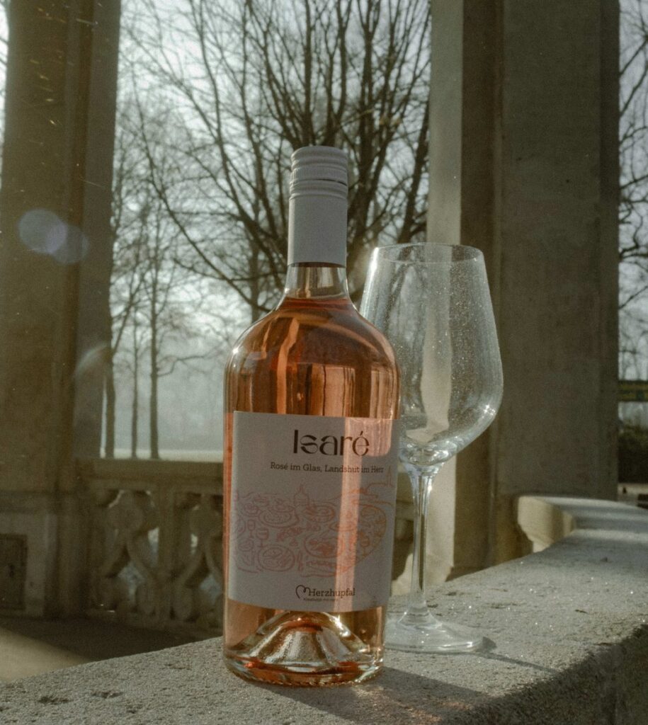 Isaré-Flasche und Weinglas auf einer Steinbrüstung im Freien